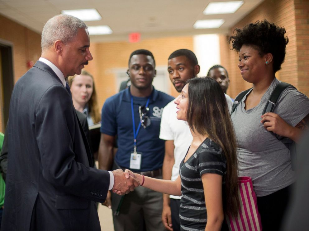 PHOTO: Attorney General Eric Holder shakes hands with Bri Ehsan, right, following his meeting with students at St. Louis Community College Florissant Valley, Aug. 20, 2014, in Ferguson, Missouri.
