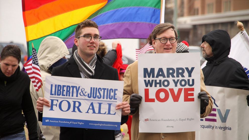 PHOTO: Spencer Geiger, left, and Carl Johansen protest for equal marriage outside the Walter E. Hoffman U.S. Courthouse as oral arguments in the case of Bostic v Rainey proceed on Feb. 4, 2014 in Norfolk, Va. 
