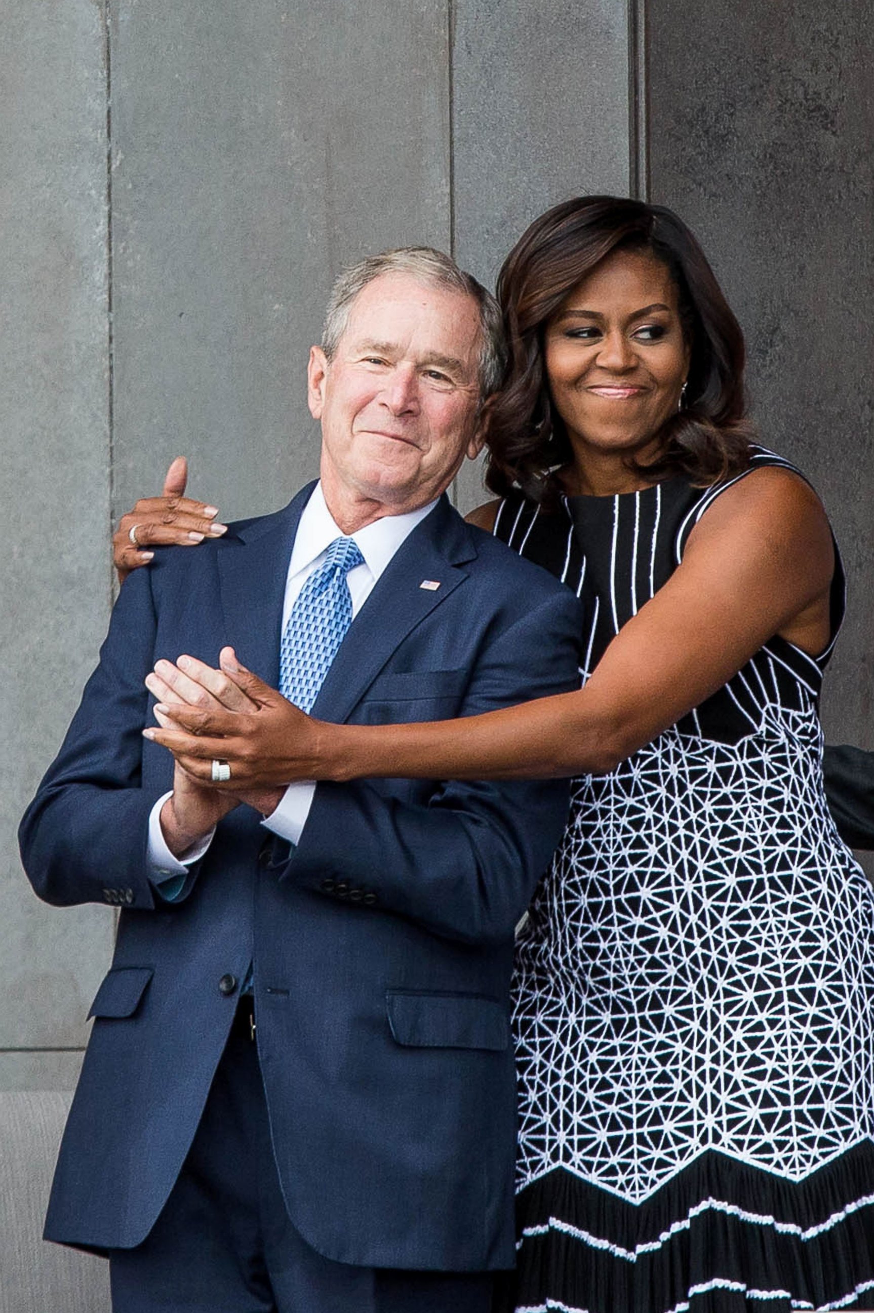 PHOTO: Former President George W. Bush receives a hug from first lady Michelle Obama as they attend the opening ceremony for the Smithsonian National Museum of African American History and Culture, Sept. 24, 2016 in Washington. 