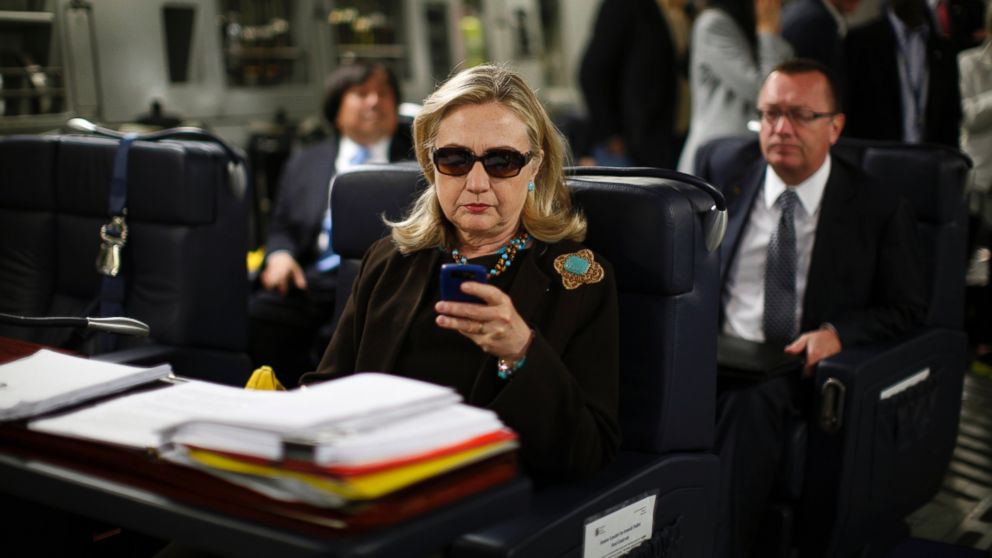 U.S. Secretary of State Hillary Clinton checks her PDA upon departure in a military C-17 plane from Malta bound for Tripoli, Oct. 18, 2011.