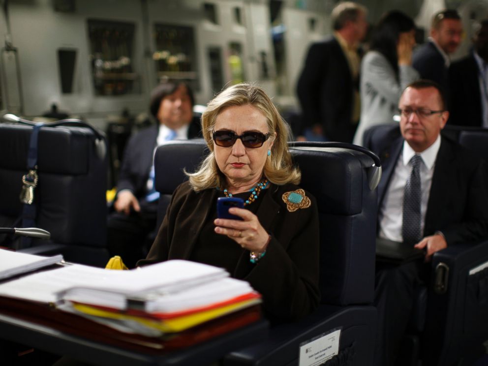 PHOTO: U.S. Secretary of State Hillary Clinton checks her PDA upon departure in a military C-17 plane from Malta bound for Tripoli, Oct. 18, 2011.