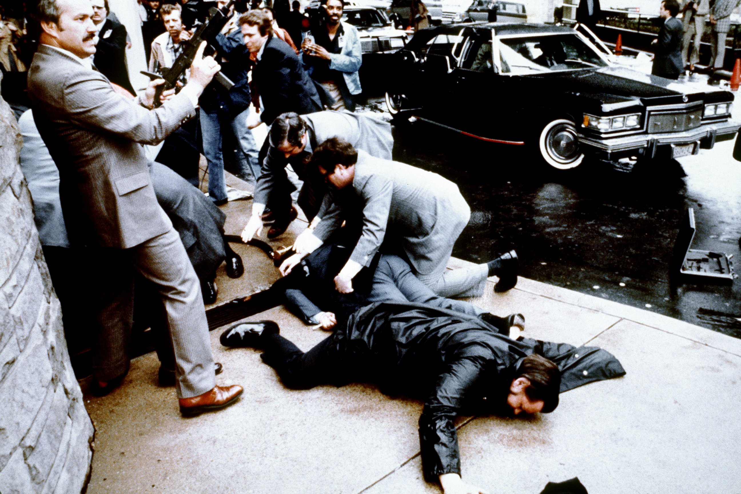 PHOTO: This photo taken by presidential photographer Mike Evens on March 30, 1981 shows police and Secret Service agents reacting during the assassination attempt on then US president Ronald Reagan, after a conference in Washington, D.C.