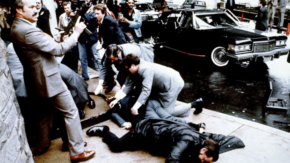 PHOTO: This photo taken by presidential photographer Mike Evens on March 30, 1981 shows police and Secret Service agents reacting during the assassination attempt on then US president Ronald Reagan, after a conference in Washington, D.C.