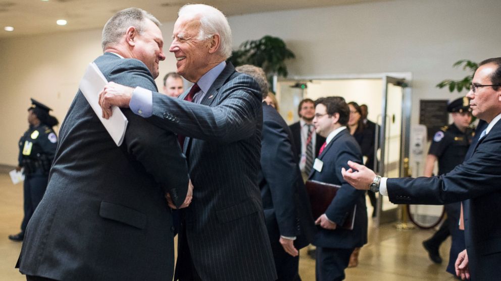 PHOTO: Vice President Joe Biden stops to speak with Sen. Jon Tester, D-Mont., as he heads to the Senate subway, March 25, 2015. 