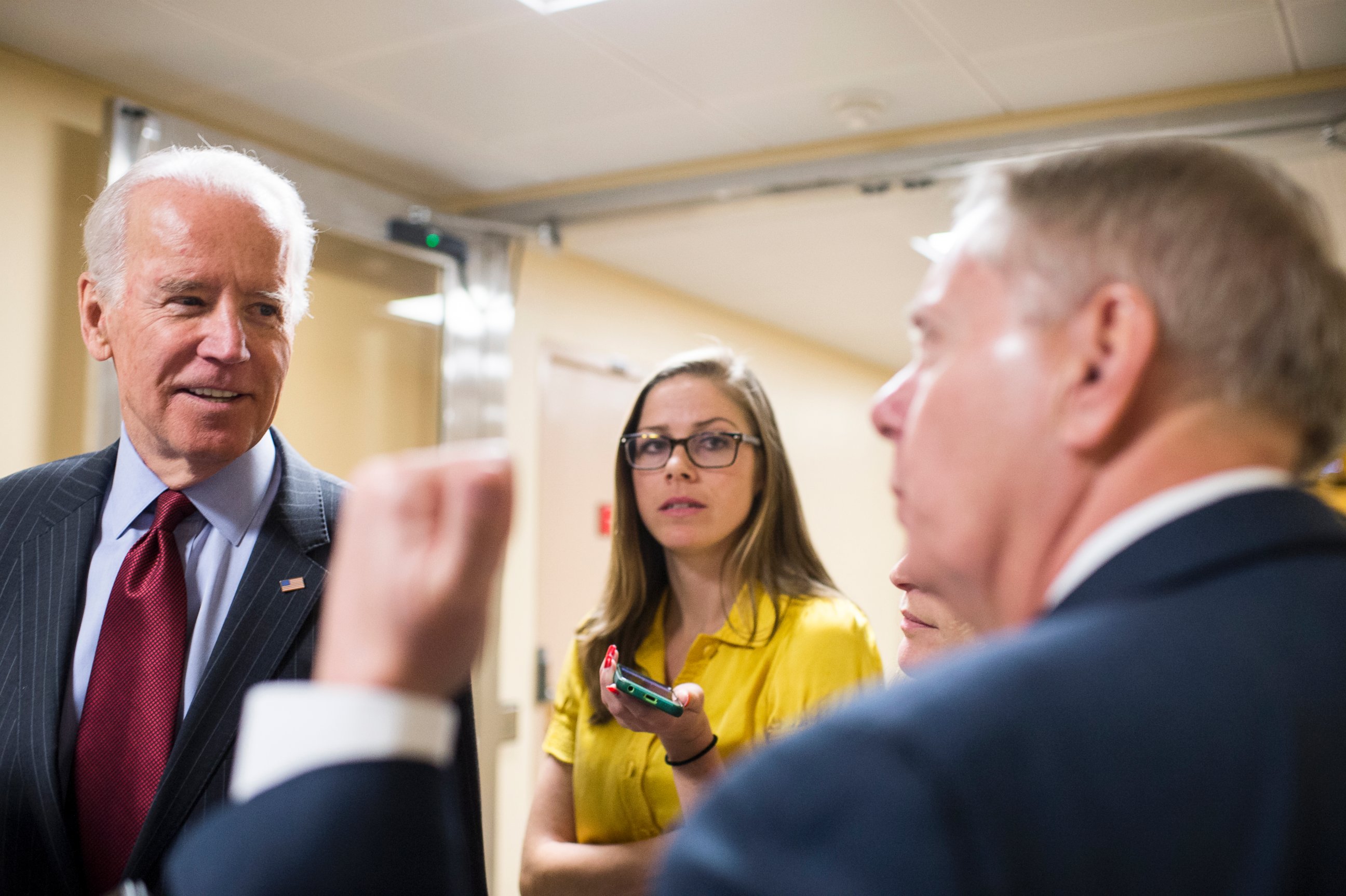 PHOTO: Vice President Joe Biden stops to speak with Sen. Lindsey Graham, R-S.C., as he heads to the Senate subway, March 25, 2015. 