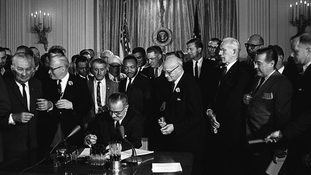 Lyndon B. Johnson signs the Civil Rights Act, July 6, 1964.