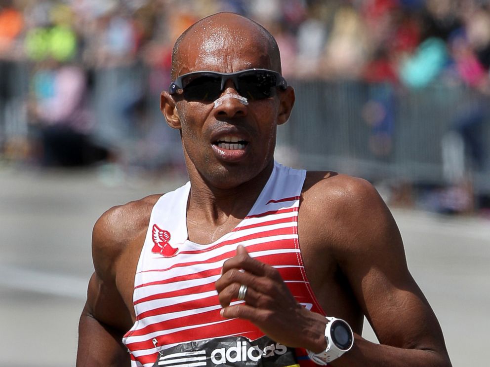 PHOTO: Mens winner Mebrahtom Keflezighi runs past Mile 18 in Newton during the 118th Boston Marathon, April 21, 2014.