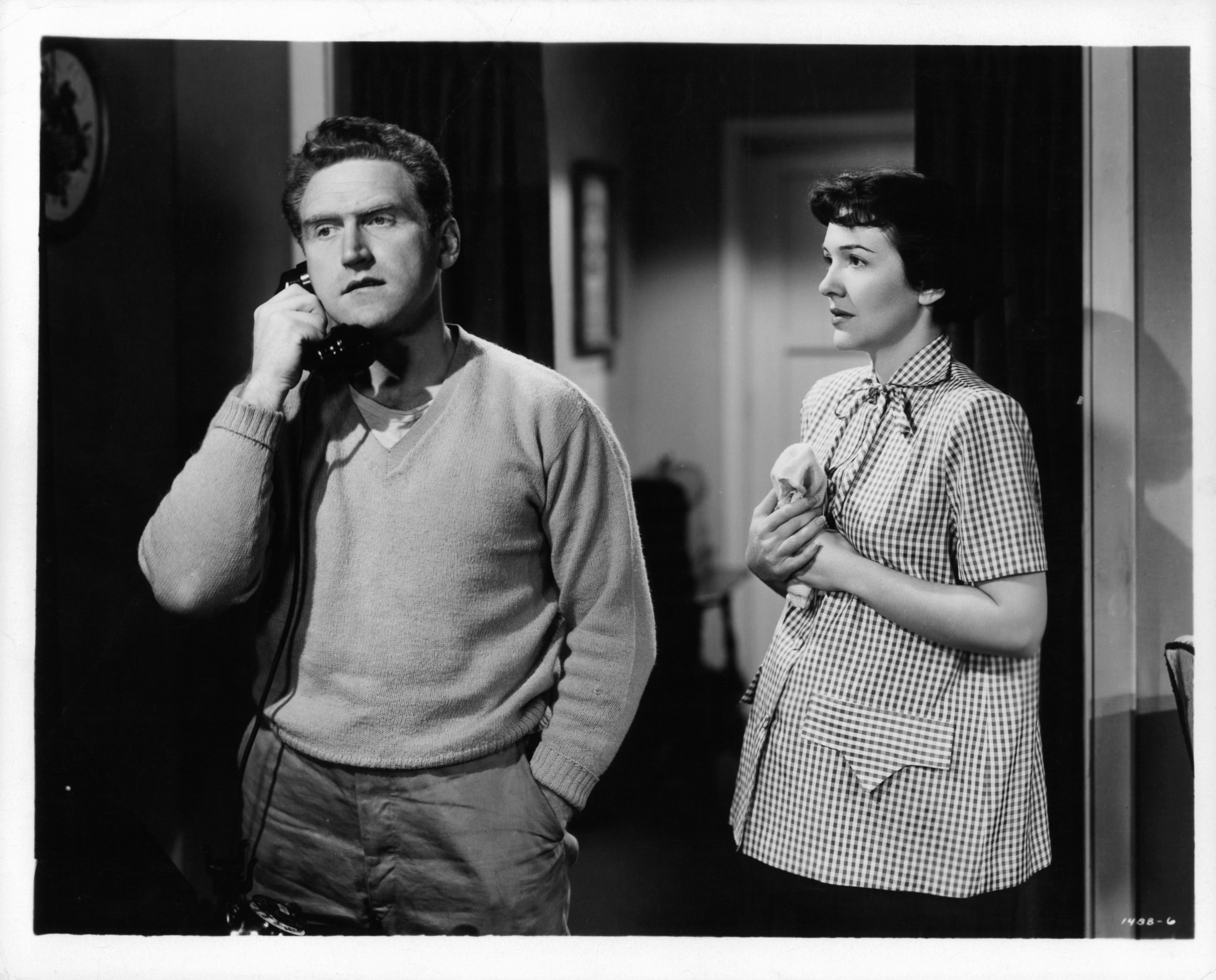 PHOTO:James Whitmore on the phone as Nancy Davis watches in a scene from the film 'The Next Voice You Hear...', 1950.  