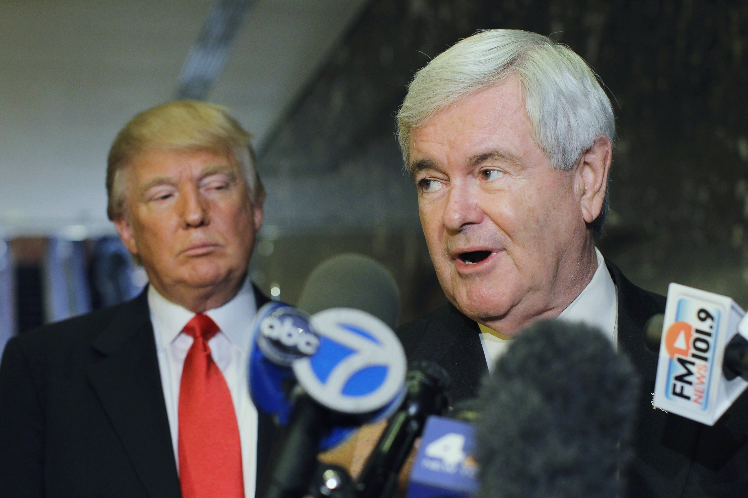 PHOTO: Newt Gingrich speaks to the media as Donald Trump listens at Trump Tower following a meeting between the two, Dec. 5, 2011, in New York.