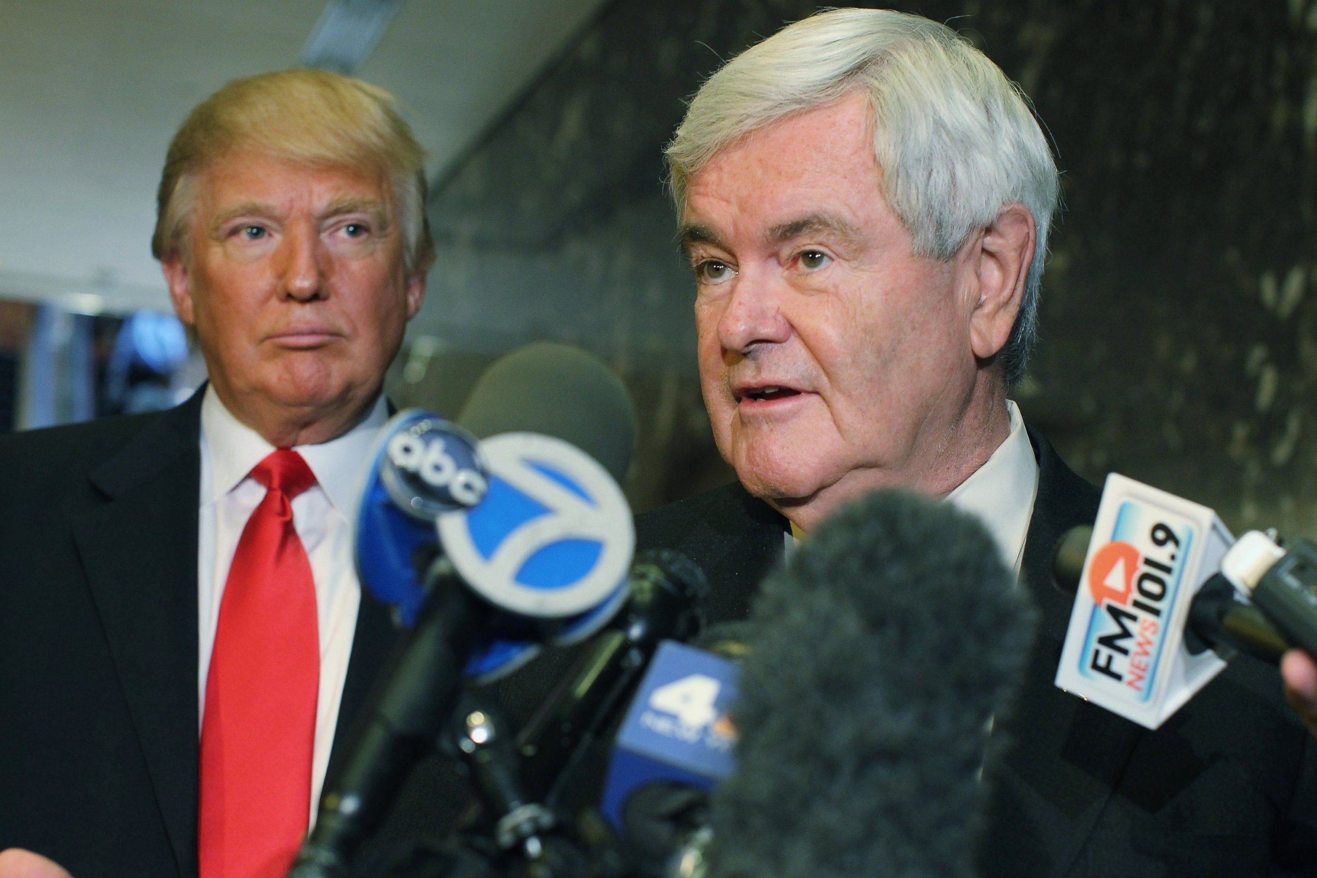 PHOTO: Newt Gingrich speaks to the media as Donald Trump listens at Trump Tower following a meeting between the two, Dec. 5, 2011 in New York City. 