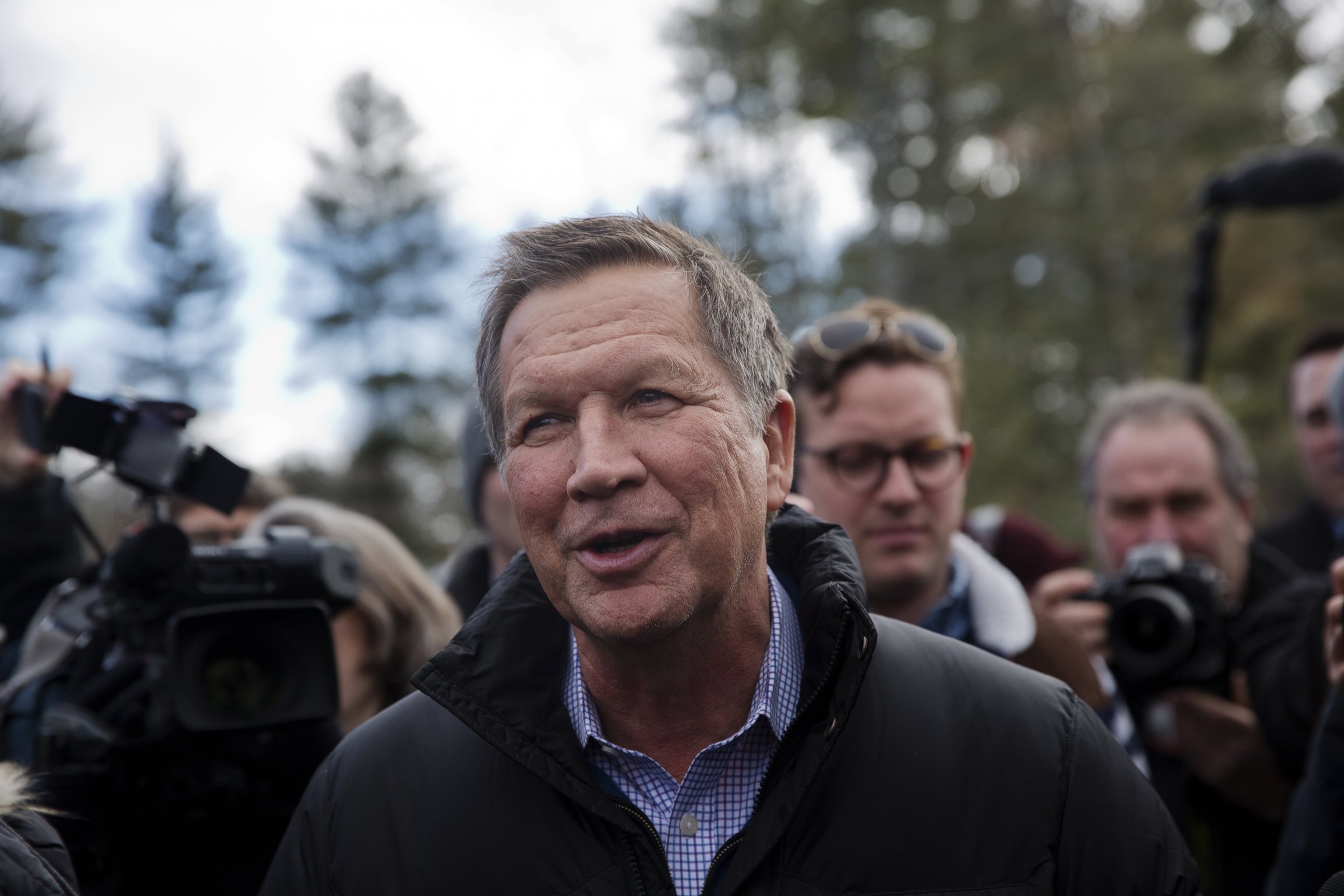 PHOTO: John Kasich, governor of Ohio and Republican presidential candidate, center, greets voters while arriving at a polling station in Concord, N.H., Feb. 9, 2016. 
