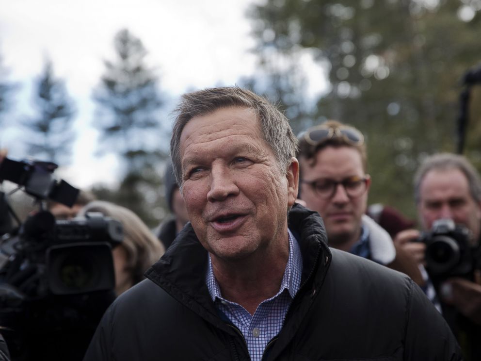 PHOTO: John Kasich, governor of Ohio and Republican presidential candidate, center, greets voters while arriving at a polling station in Concord, N.H., Feb. 9, 2016.