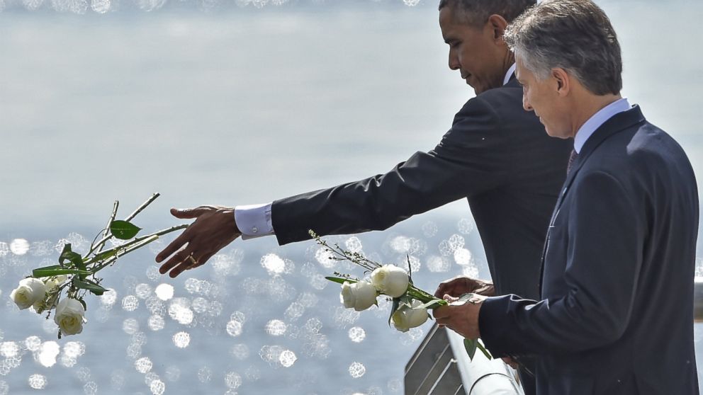 President Obama and Argentinian President Mauricio Macri throw white flowers into the River as they pay homage to Dirty War's victims at the "Parque de la Memoria" in Buenos Aires, March 24, on the 40th anniversary of the 1976 military coup.