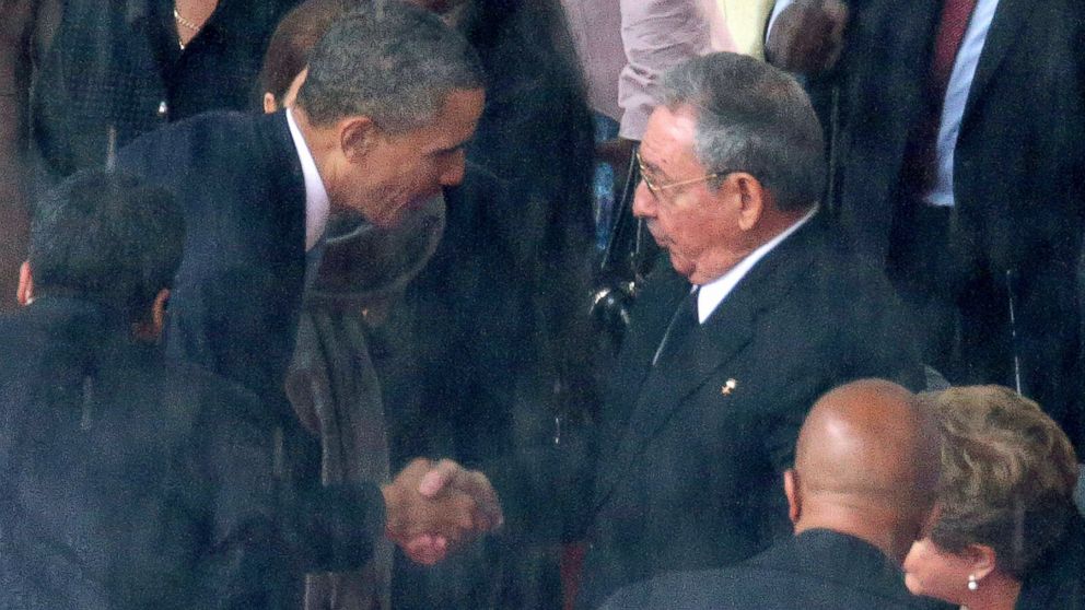 PHOTO: President Barack Obama, left, shakes hands with Cuban President Raul Castro during the official memorial service for former South African President Nelson Mandela at FNB Stadium, Dec. 10, 2013, in Johannesburg.