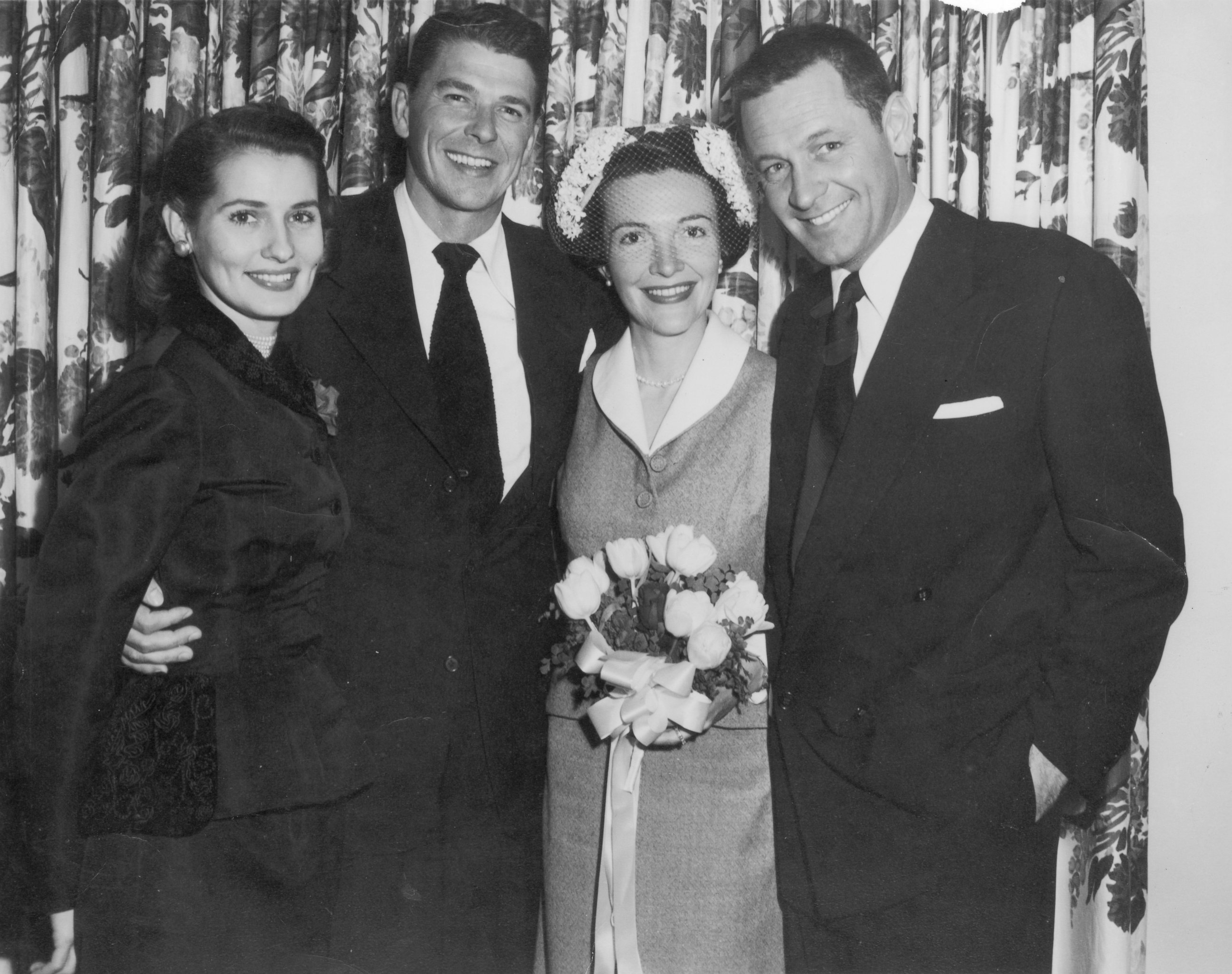 PHOTO: Portrait of American actors Ronald Reagan and Nancy Davis (center) on their wedding day with their arms wrapped around Best Man, American actor William Holden, and Maid of Honor, Phillipine-born actor Brenda Marshall, circa 1952.  