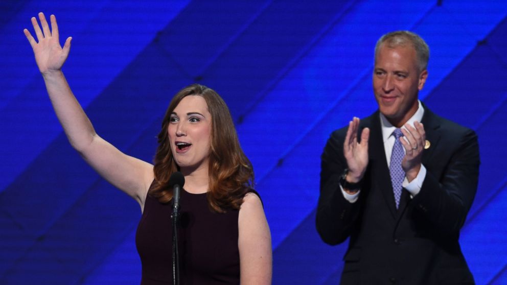 LGBT rights activist Sarah McBride and co-Chair of the Congressional LGBT Equality Caucus, Congressman Sean Patrick Maloney of New York acknowledge applause at the end of their address on the fourth and final day of the Democratic National Convention on July 28, 2016, in Philadelphia.