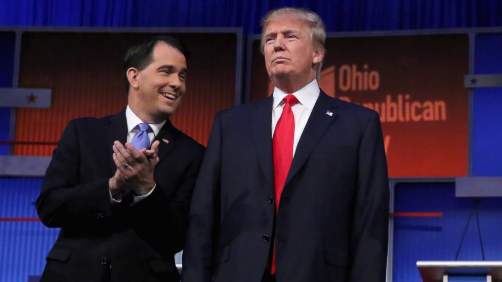 Republican presidential candidates Wisconsin Gov. Scott Walker and Donald Trump take the stage for the first prime-time presidential debate hosted by FOX News and Facebook at the Quicken Loans Arena Aug. 6, 2015 in Cleveland, Ohio. 