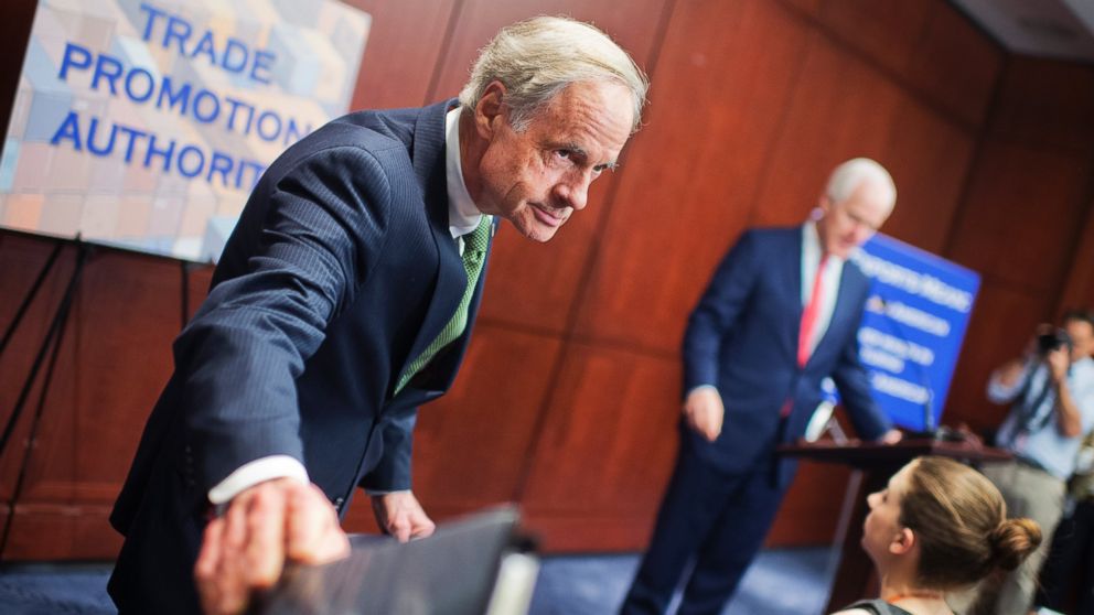From left, Sen. Tom Carper and Senate Majority Whip John Cornyn arrive for a news conference in the Capitol Visitor Center to express support for passage of the Trade Promotion Authority legislation, May 12, 2015.