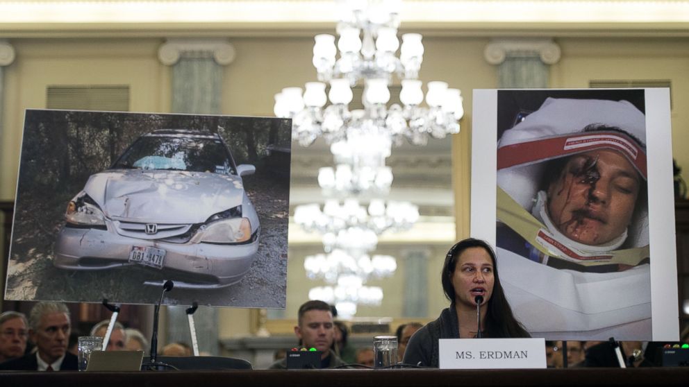 Air Force Lt. Stephanie Erdman, whose eye was injured by airbag shrapnel from her 2002 Honda Civic, is surrounded by pictures showing the accident as she testifies before the US Senate Committee on Commerce, Science, and Transportation on Capitol Hill in Washington, Nov. 20, 2014, on the Takata airbag defects and the vehicle recall process.