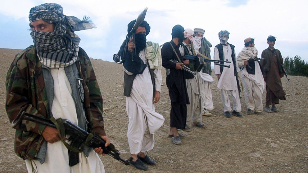 Fighters with Afghanistan's Taliban militia stand on a hillside at Maydan Shahr in Wardak province, west of Kabul, in this Sept. 26, 2008 file photo.