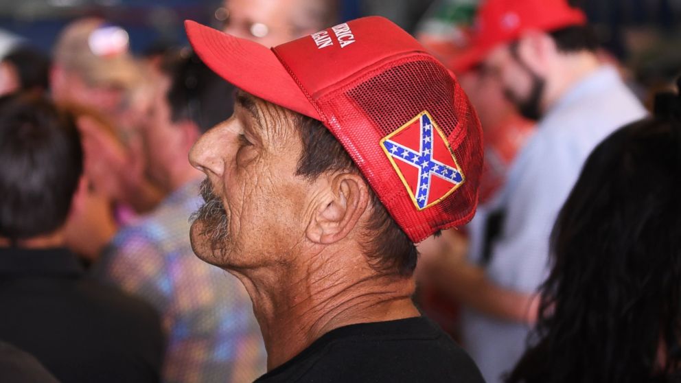 A man has a confederate flag on his "Make America Great" hat during a Donald Trump rally at the Wings Over the Rockies Museum in Denver, July 29, 2016. 