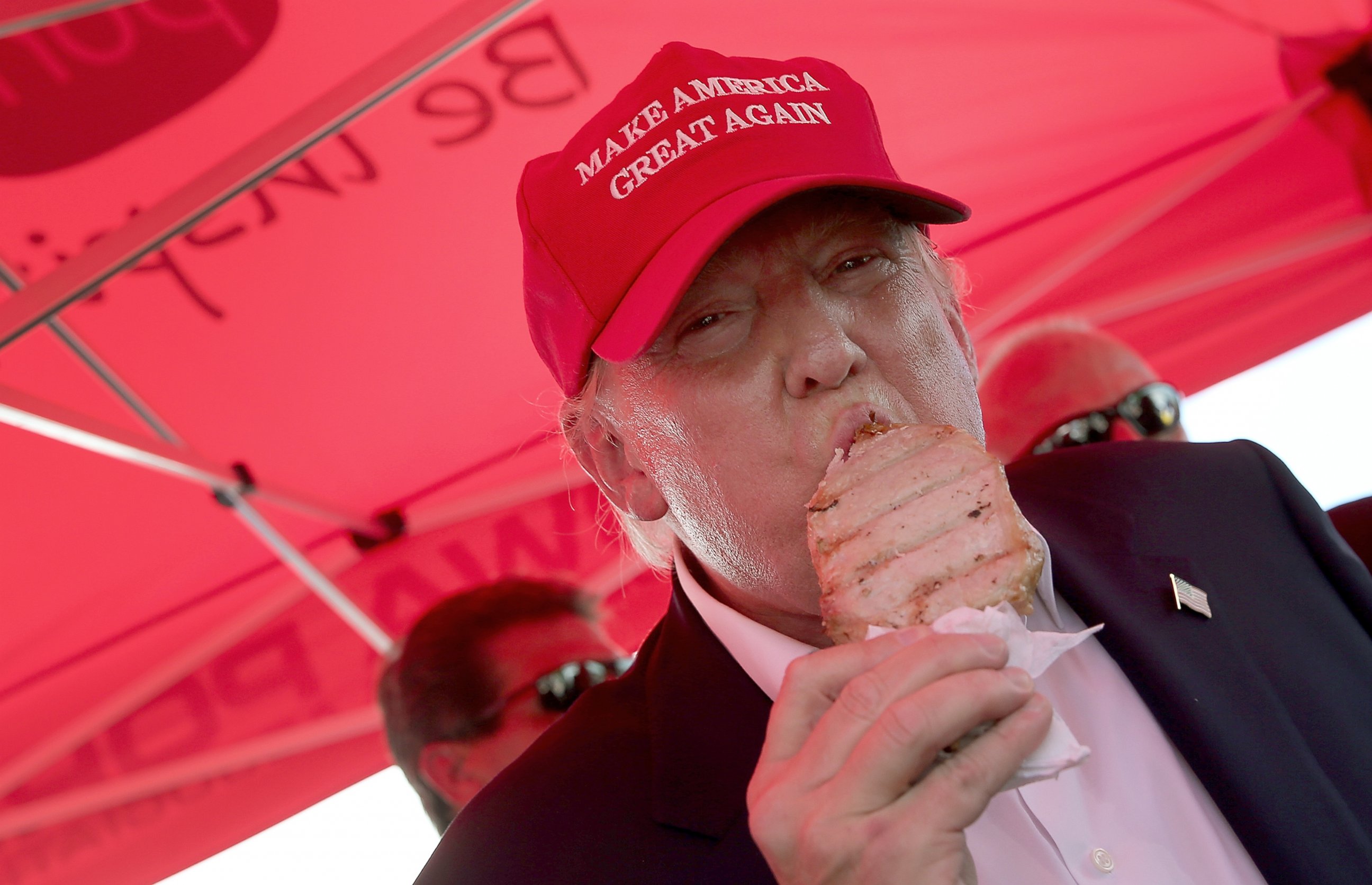 PHOTO: Republican presidential candidate Donald Trump eats a pork chop on a stick and gives a thumbs up sign to fairgoers at the Iowa State Fair, August 15, 2015, in Des Moines, Iowa.