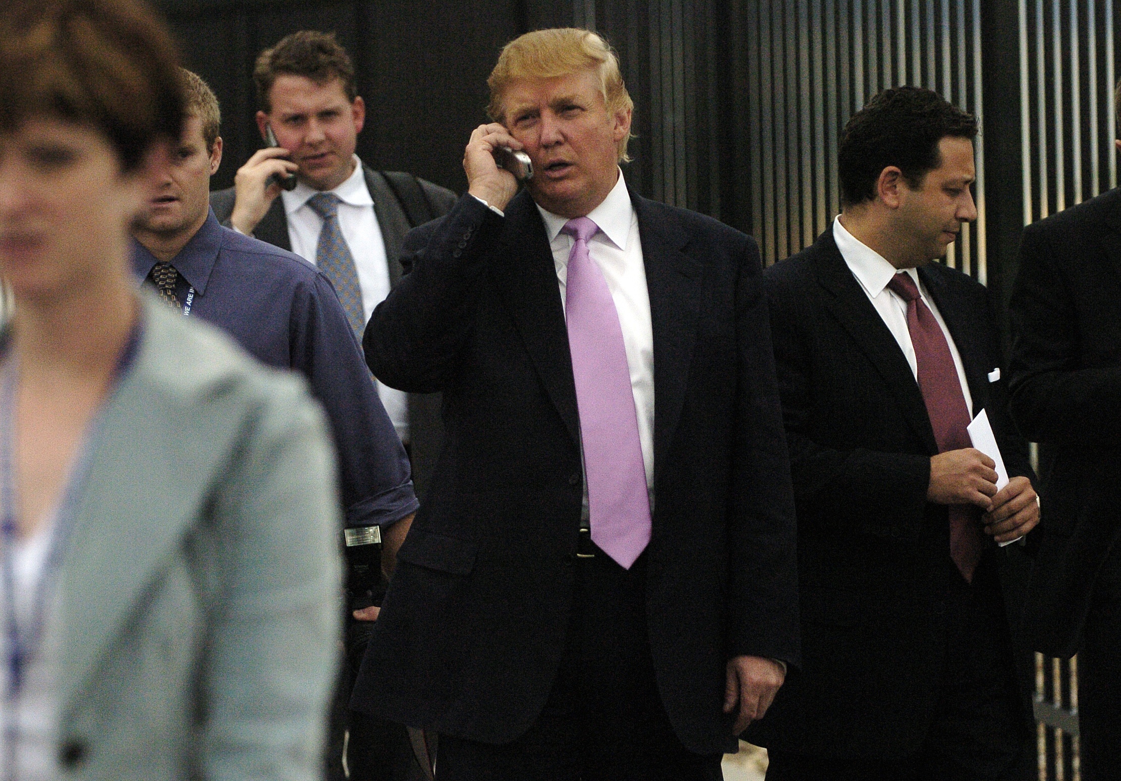 PHOTO: Donald Trump exits the Budweiser Events Center after talking at the Bixpo 2005 convention in Loveland, Colo., Sept. 14, 2005. Felix Sater appears in the red tie on Trump's left.  