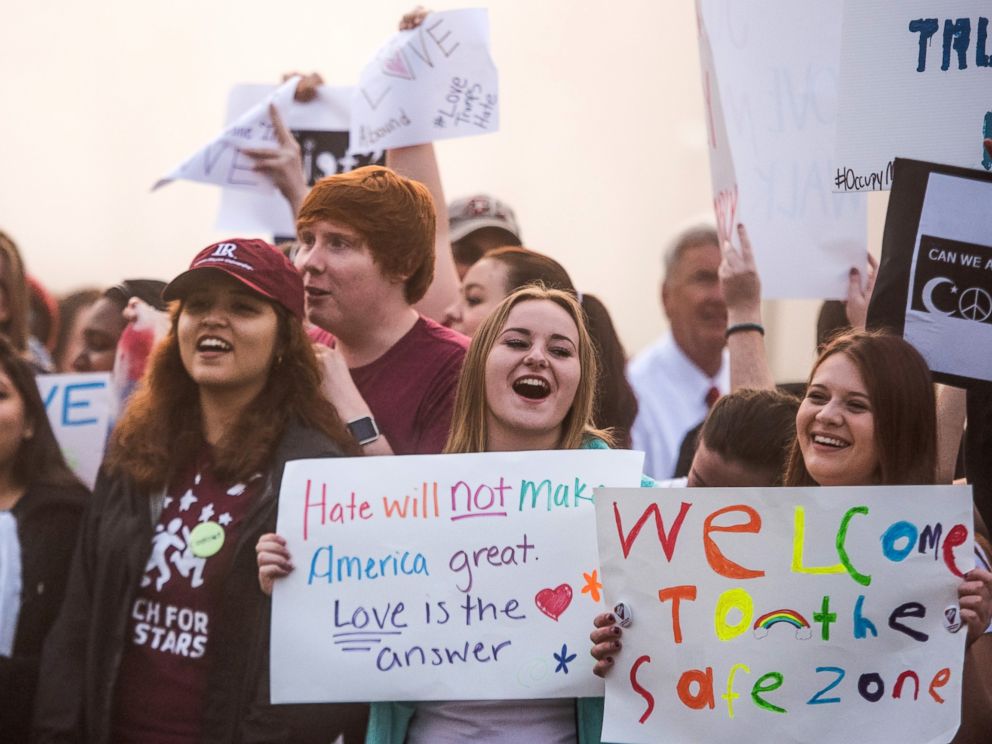 PHOTO: Donald Trump protesters voice their opinion and sing Where is the Love by the Black Eyed Peas before a campaign rally at Lenoir-Rhyne University, March 14, 2016, in Hickory, North Carolina.