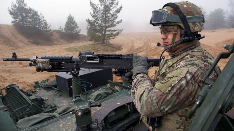 A soldier is shown manning a gun on an armored fighting vehicle IAV Stryker of the U.S. Cavalry Regiment 2nd subdivision during a partner training with Latvian an Canadian soldiers at the Adazi military training area in Latvia, Feb. 26, 2015.