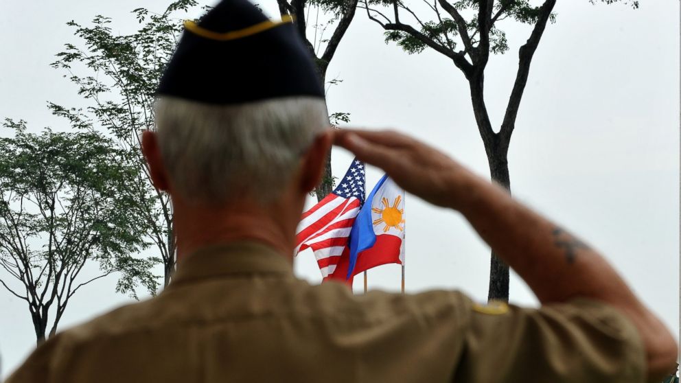 A retired American soldier salutes to the colors during Veterans Day celebration at the American Cemetery in Manila, Nov. 11, 2010.