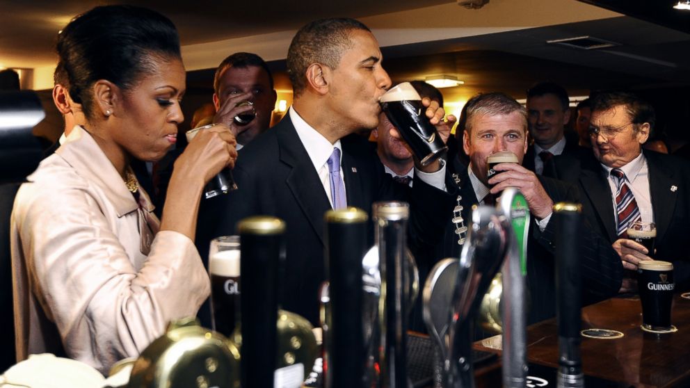 Michelle Obama and President Barack Obama sip Guinness at a pub as they visit Moneygall village in rural County Offaly, Ireland, where his great-great-great grandfather Falmouth Kearney hailed from, May 23, 2011.
