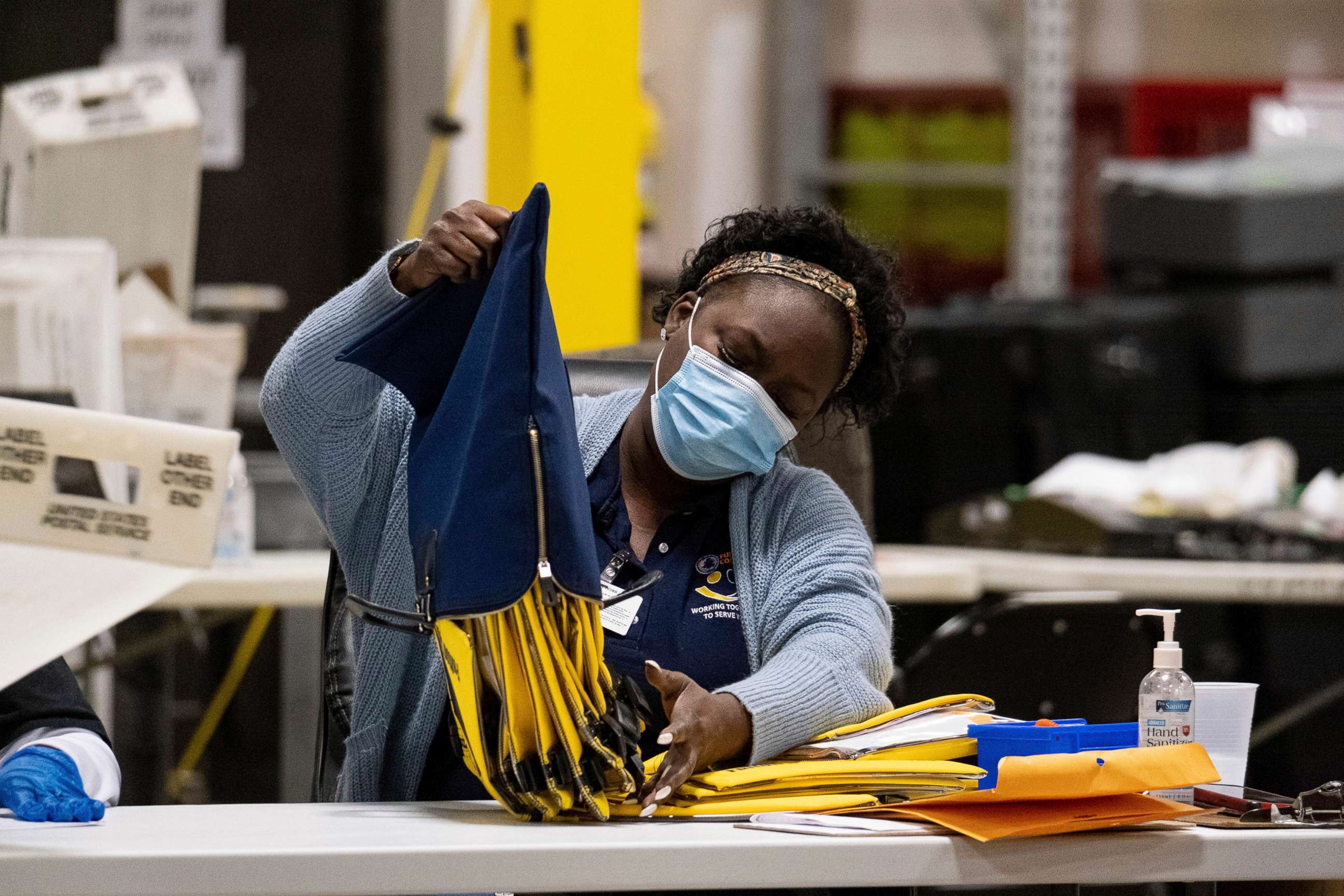 PHOTO: An election worker at the Fulton County Georgia elections warehouse empties a bag following the Senate runoff election in Atlanta, Jan. 5, 2021. 