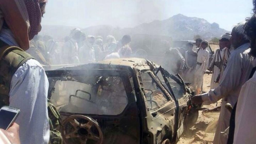 PHOTO: Yemenis gather around a burnt car after it was targeted by a drone strike killing three suspected al-Qaeda militants, Jan. 26, 2015 between the Marib and Chabwa provinces, a desert area east of Sanaa. 