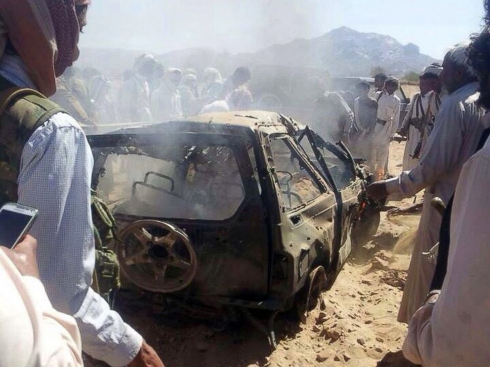 PHOTO: Yemenis gather around a burnt car after it was targeted by a drone strike killing three suspected al-Qaeda militants, Jan. 26, 2015 between the Marib and Chabwa provinces, a desert area east of Sanaa.