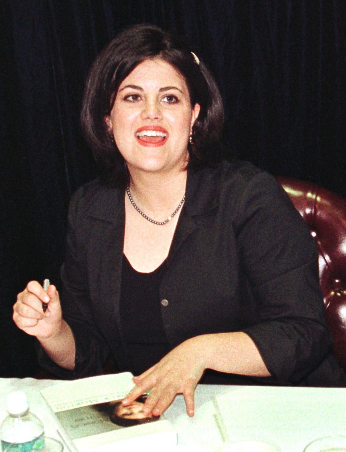 PHOTO: Monica Lewinsky looks up as she signs her book, 'Monica's story', during a signing April, 23, 1999, at a book store in Fort Lauderdale, Florida. 