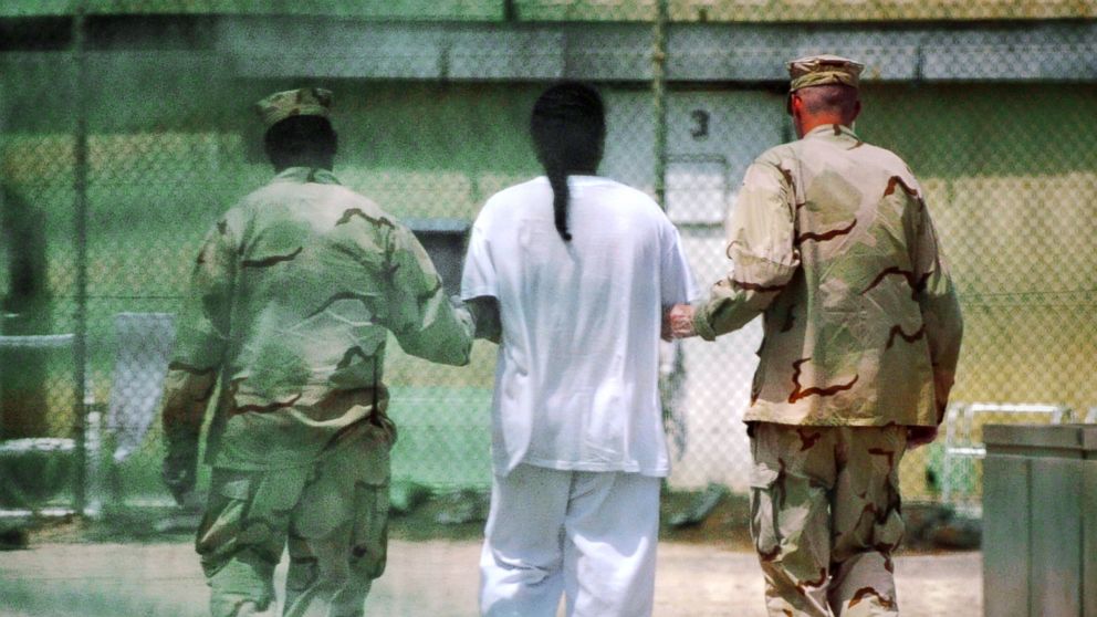 A detainee is escorted at Camp Delta detention facility in Guantanamo Bay, Cuba, April 19, 2010. 
