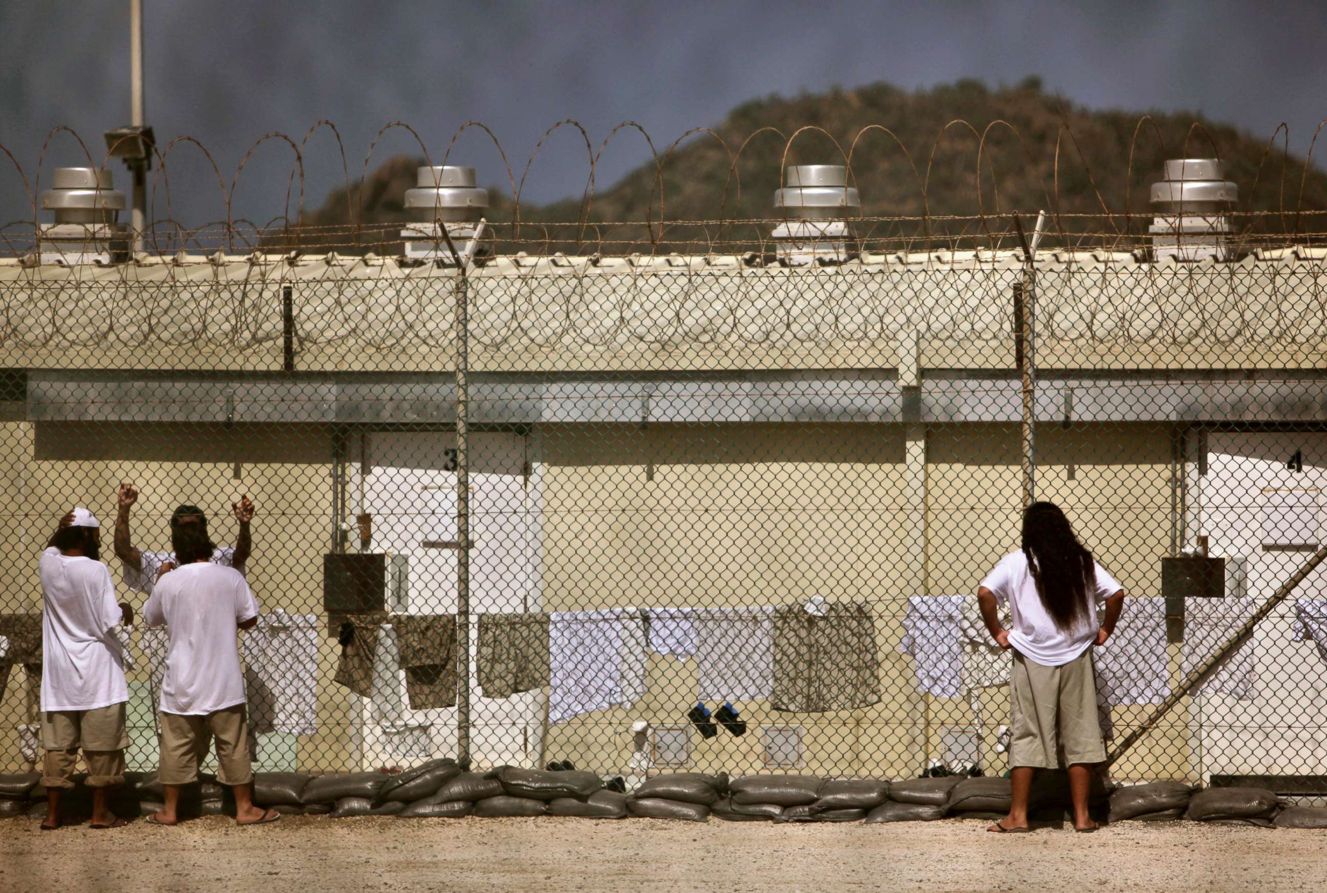 PHOTO: Detainees talk together inside the open-air yard at the Camp 4 detention facility at Guantanamo Bay U.S. Naval Base in Cuba, May 31, 2009.