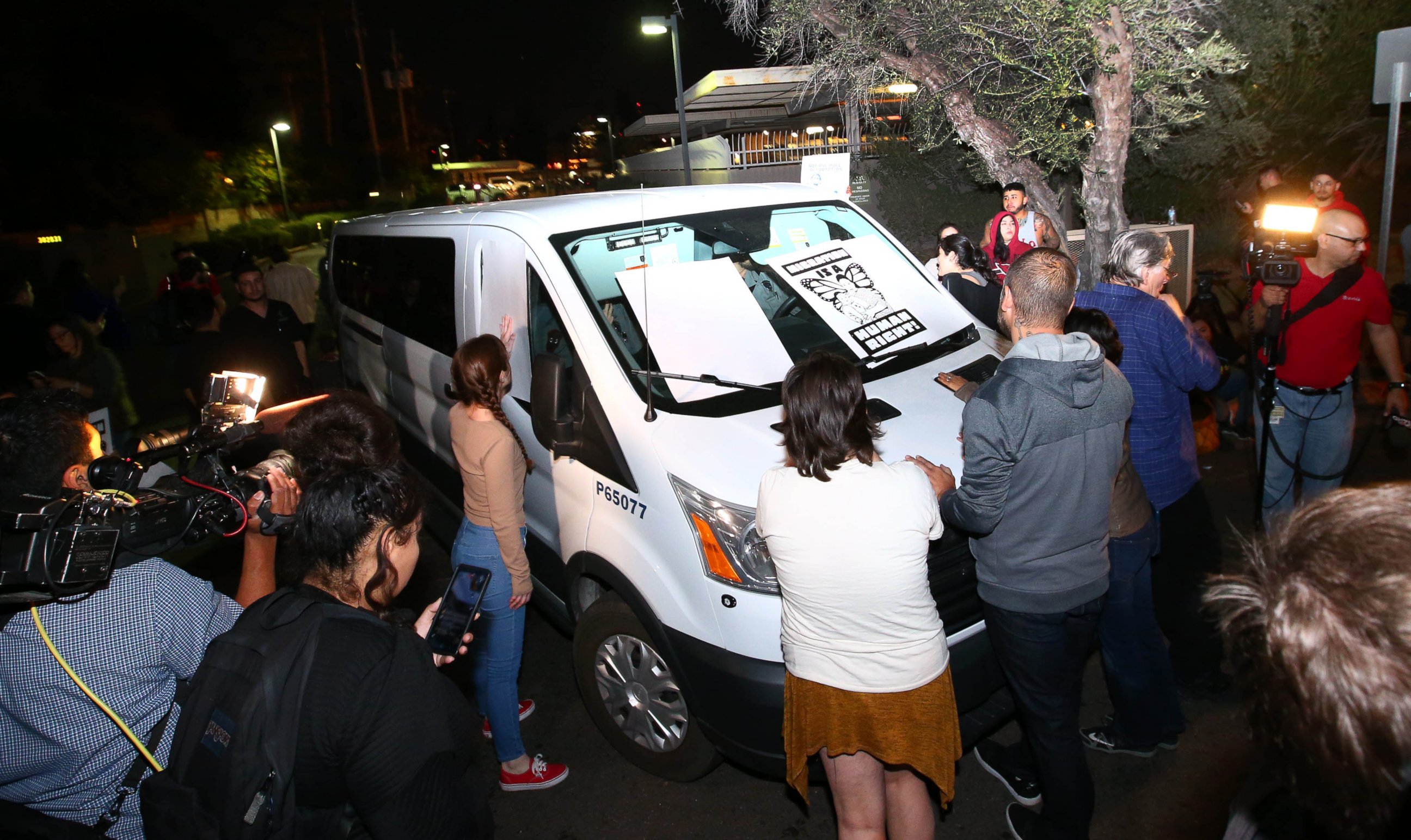 PHOTO: Protesters surrounding the van that Guadalupe Garcia de Rayos was locked in outside the ICE office in Phoenix, Ariz., Feb. 8, 2017.