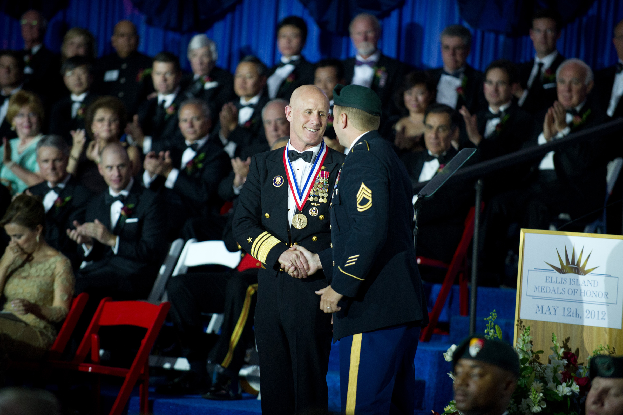 PHOTO: U.S. Navy Vice Adm. Robert S. Harward receives the Ellis Island Medal of Honor Award from a U.S. Army Special Forces soldier during a ceremony, May 12, 2012, at Ellis Island in New York.