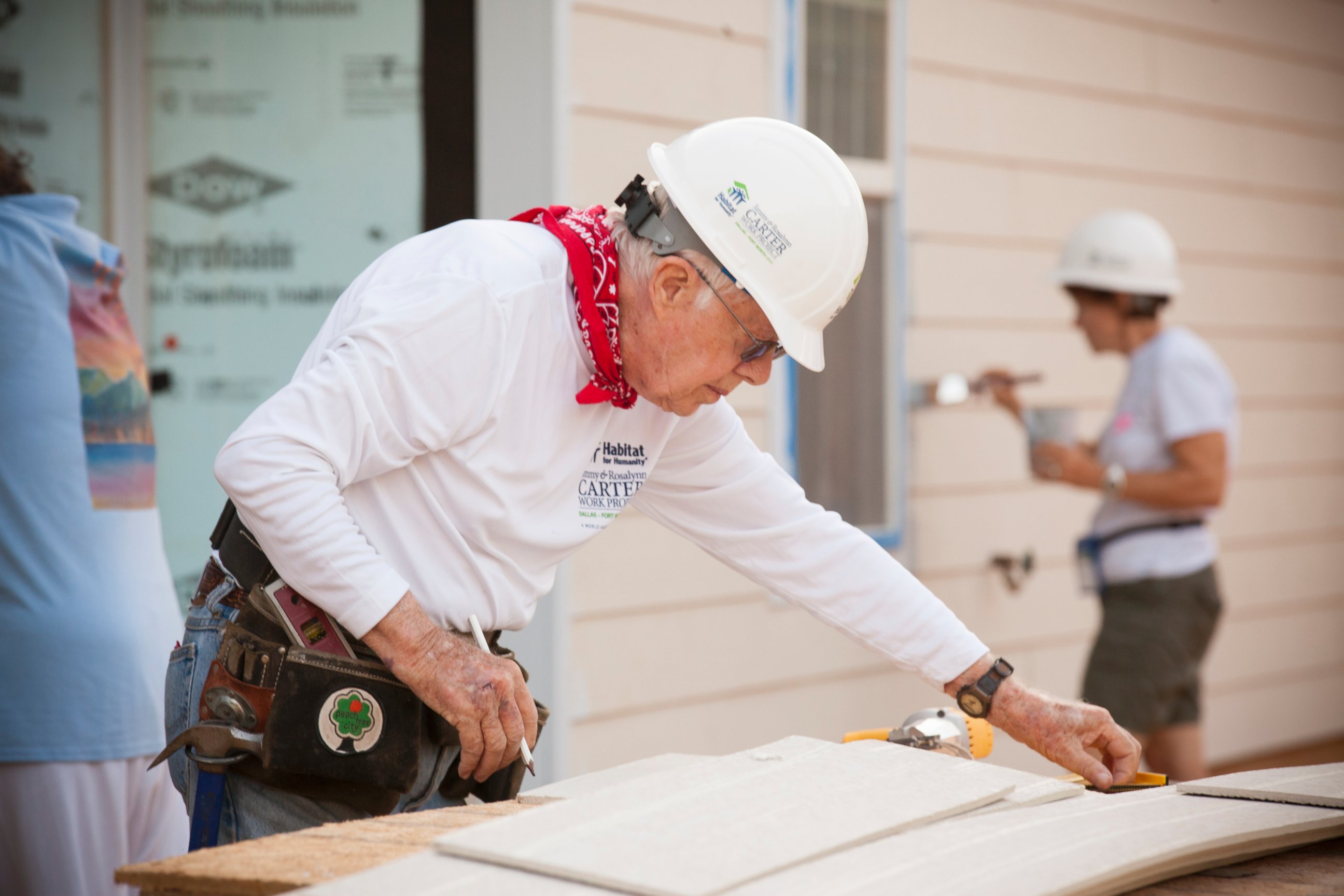 PHOTO: Former President Jimmy Carter helps to install siding on a new home during the 2014 Jimmy & Rosalynn Carter Work Project in Dallas. 