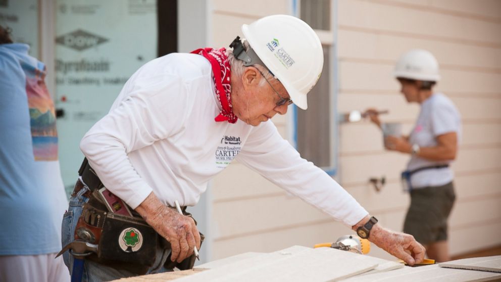 PHOTO: Former President Jimmy Carter helps to install siding on a new home during the 2014 Jimmy & Rosalynn Carter Work Project in Dallas. 