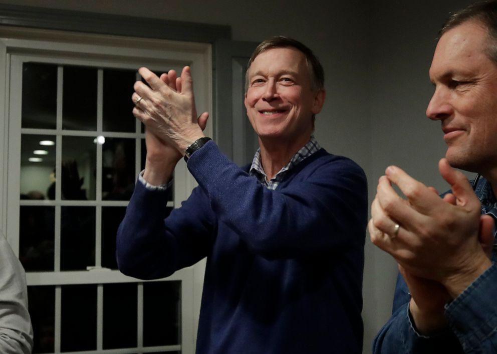 PHOTO:Former Colorado Gov. John Hickenlooper, left, applauds at a campaign house party, Feb. 13, 2019, in Manchester, N.H.