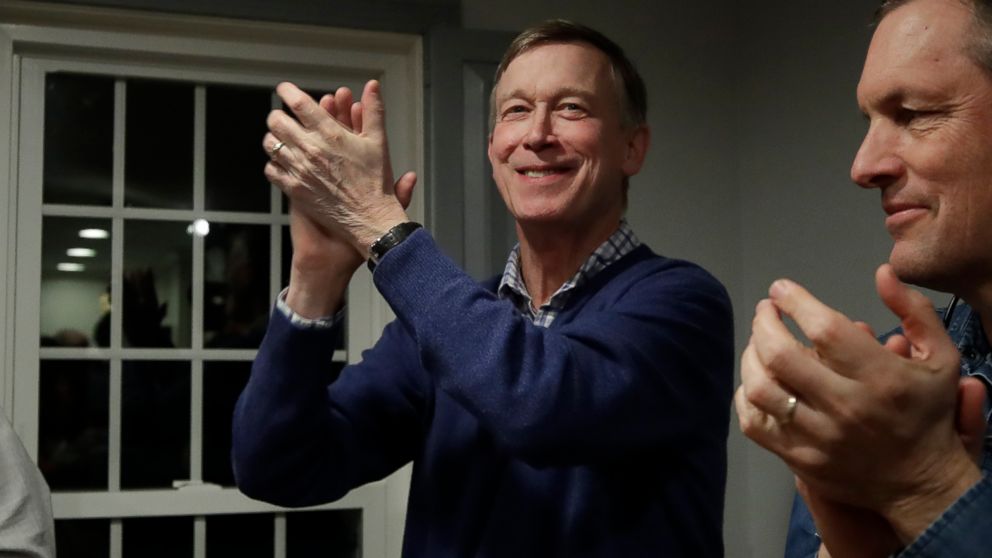  Former Colorado Gov. John Hickenlooper, left, applauds at a campaign house party, Feb. 13, 2019, in Manchester, N.H. Hickenlooper is contemplating a run for the Democratic presidential candidacy.
					