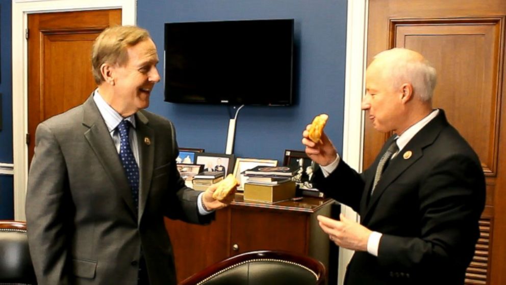 Rep. Robert Pittenger, R-North Carolina, delivers on his Super Bowl wager with Rep. Mike Coffman, Colorado. 