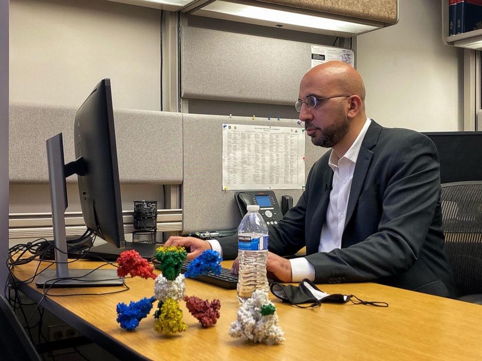 PHOTO: Dr. Kayvon Modjarrad sits at his desk adorned with a 3-D model of the vaccine he co-invented. Modjarrad is the director of the emerging infectious diseases branch of the Walter Reed Army Institute of Research (WRAIR).