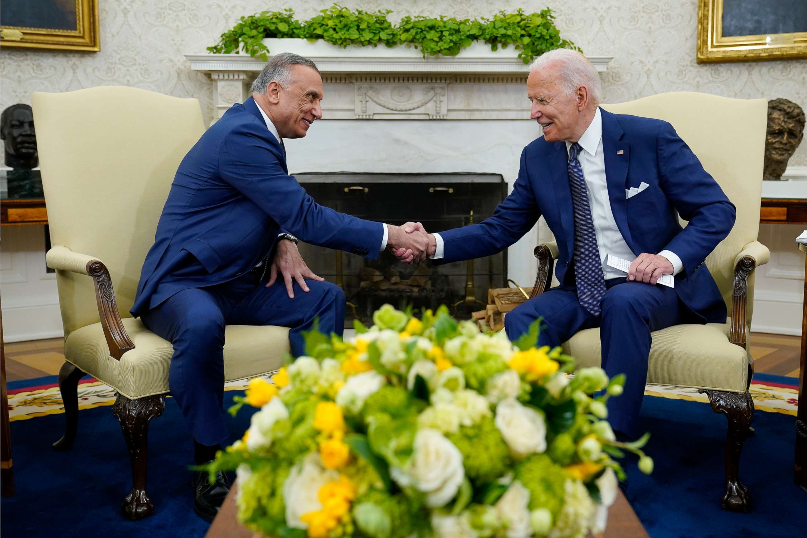 PHOTO: President Joe Biden, right, shakes hands with Iraqi Prime Minister Mustafa al-Kadhimi, left, during their meeting in the Oval Office of the White House, July 26, 2021. 