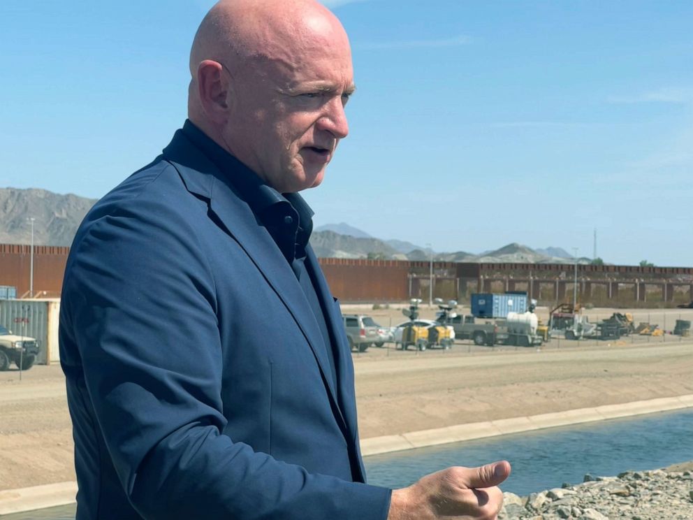PHOTO: Sen. Mark Kelly, D-Ariz., speaks to reporters at the border wall in Yuma, Arizona, on Aug. 10, 2022, about immigration and the state's water crisis. 