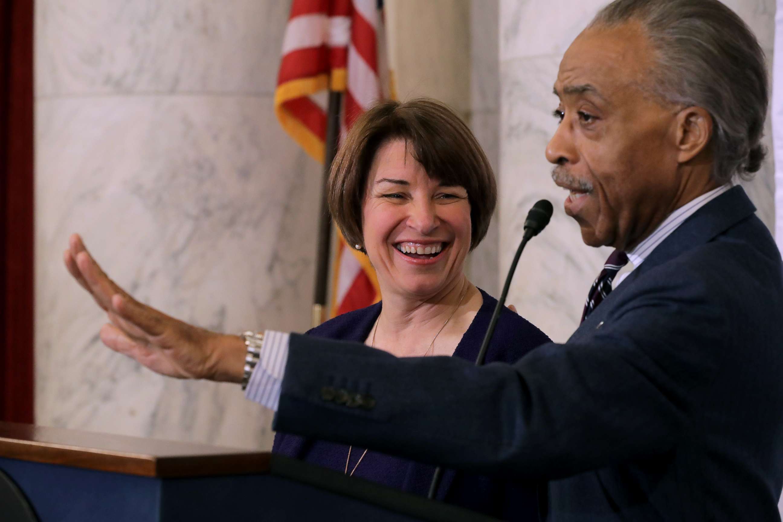PHOTO: The Rev. Al Sharpton welcomes Sen. Amy Klobuchar (D-MN) to the podium before she addresses a post-midterm election meeting of Sharpton's National Action Network on Capitol Hill, Nov. 13, 2018. 