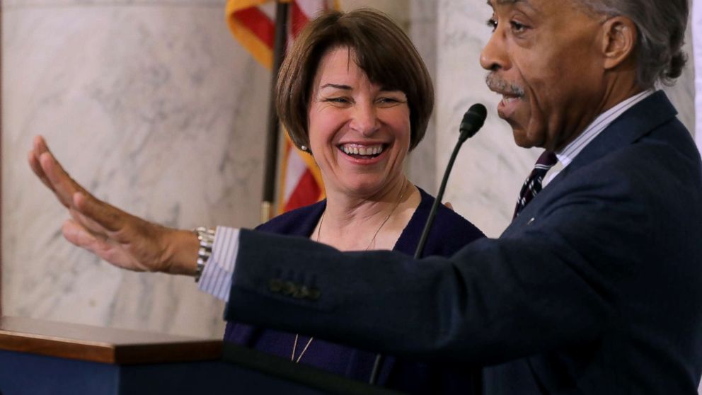 The Rev. Al Sharpton welcomes Sen. Amy Klobuchar (D-MN) to the podium before she addresses a post-midterm election meeting of Sharpton's National Action Network on Capitol Hill, Nov. 13, 2018.