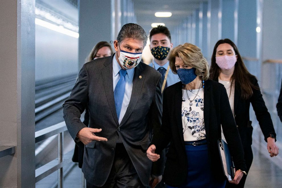 Sen. Joe Manchin, D-W.Va., and Sen. Lisa Murkowski, R-Alaska, speak as they arrive to vote in the U.S. Capitol on Feb. 23, 2021.